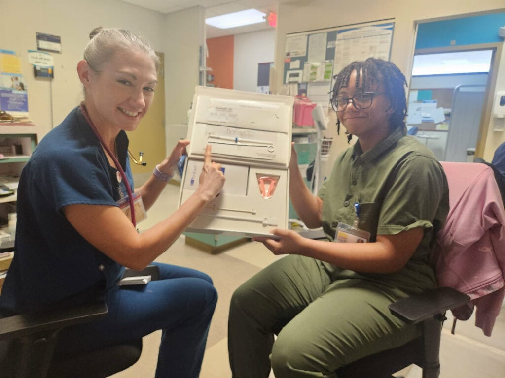 Two people looking at a chart in a hospital